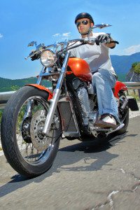 Man Sitting on His Red Motorcycle